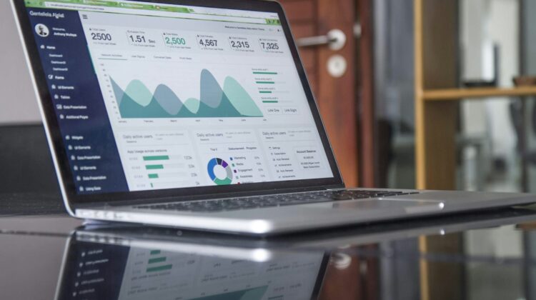 Laptop showing a business analytics dashboard with charts